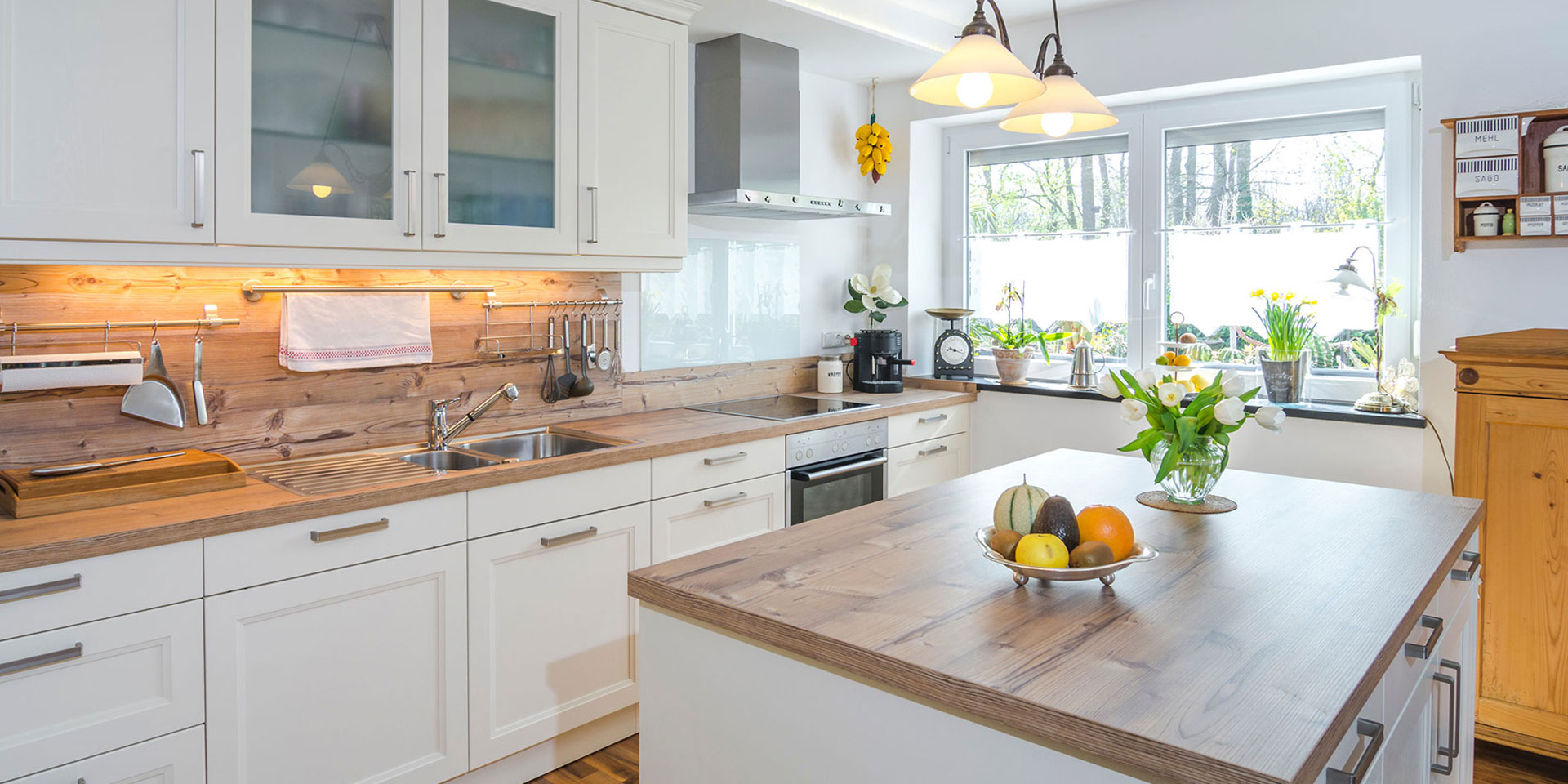 Cottage style kitchen with cream cupboard doors and hardwood worktops