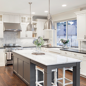 Grey modern kitchen with white units, and kitchen island, and stone worktops