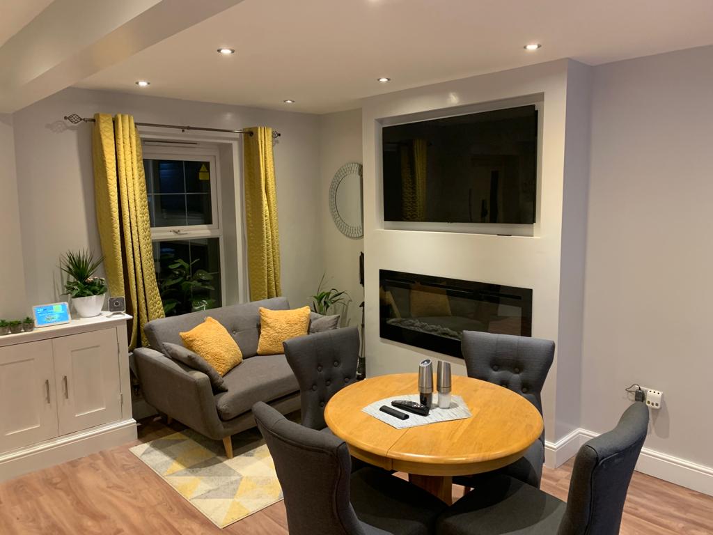 Refurbished dining room with media wall and luxury vinyl flooring