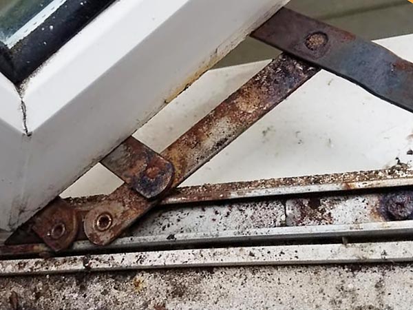 Rusty UPVC window hinge