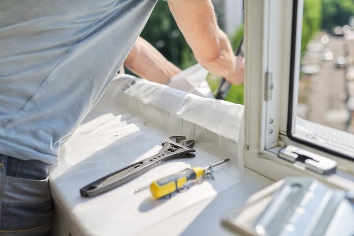 contractor fixing a window seal