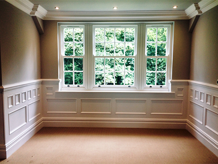 white wall panelling around window