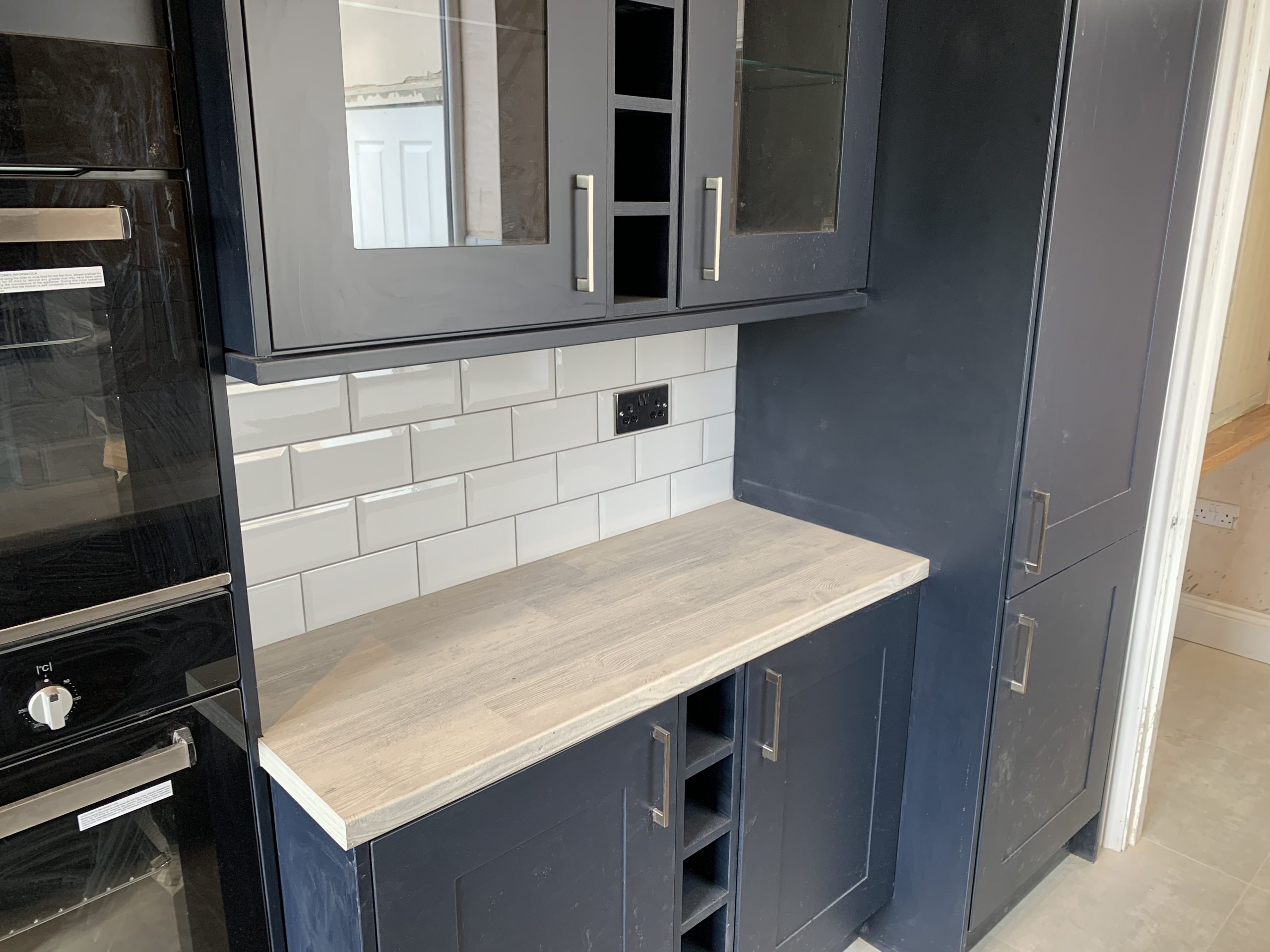 Blue kitchen with grey worktop