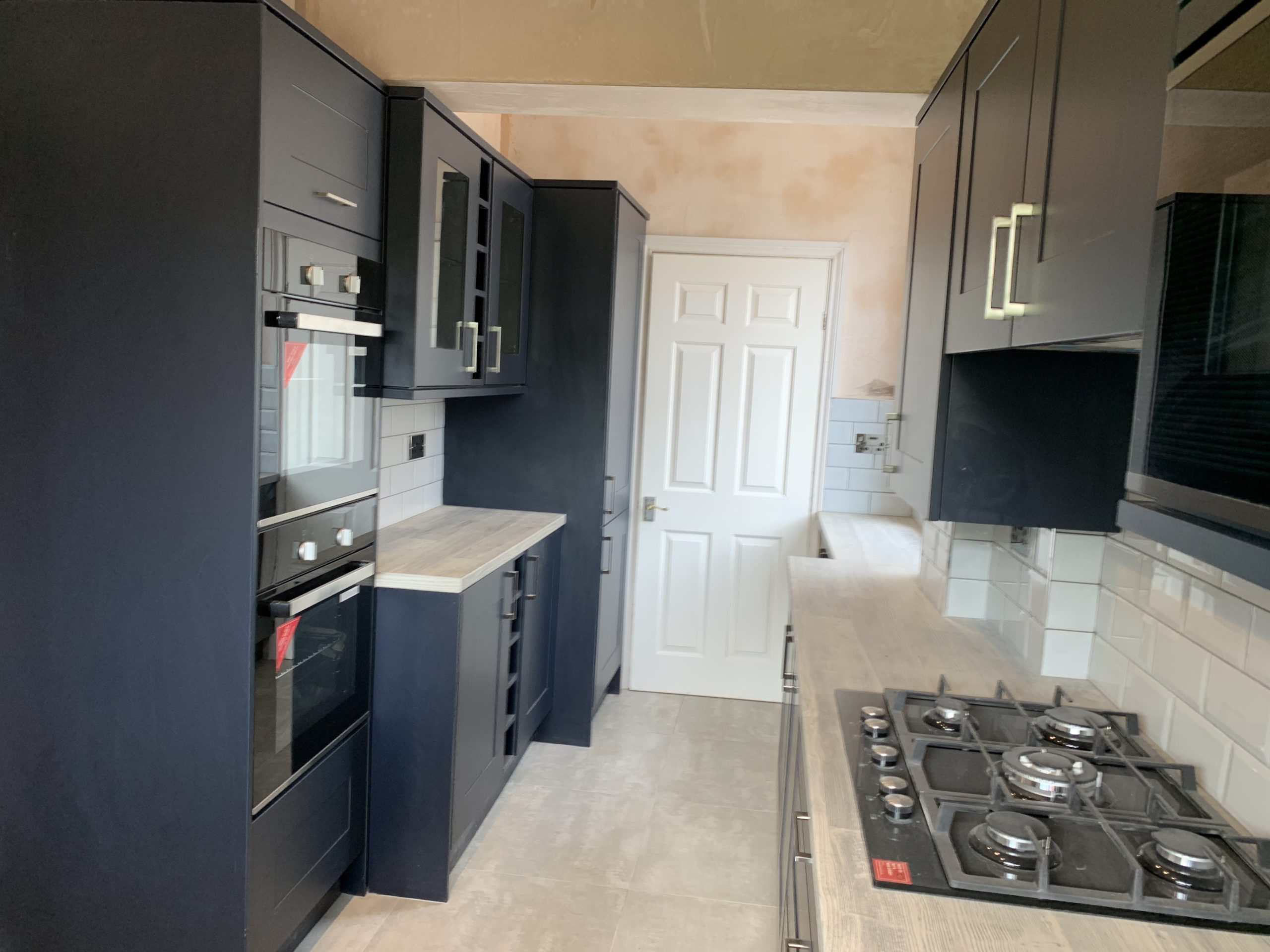 Blue kitchen with grey worktop