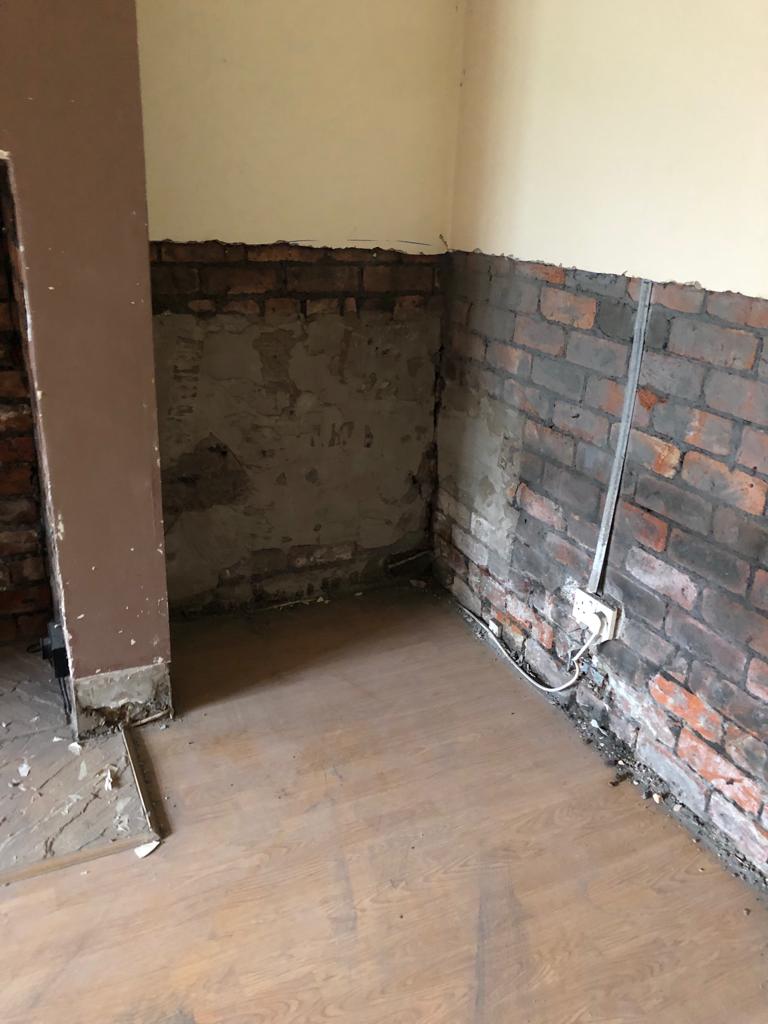 wall where plaster has been removed to allow new membrane to be installed an prevent damp penetration