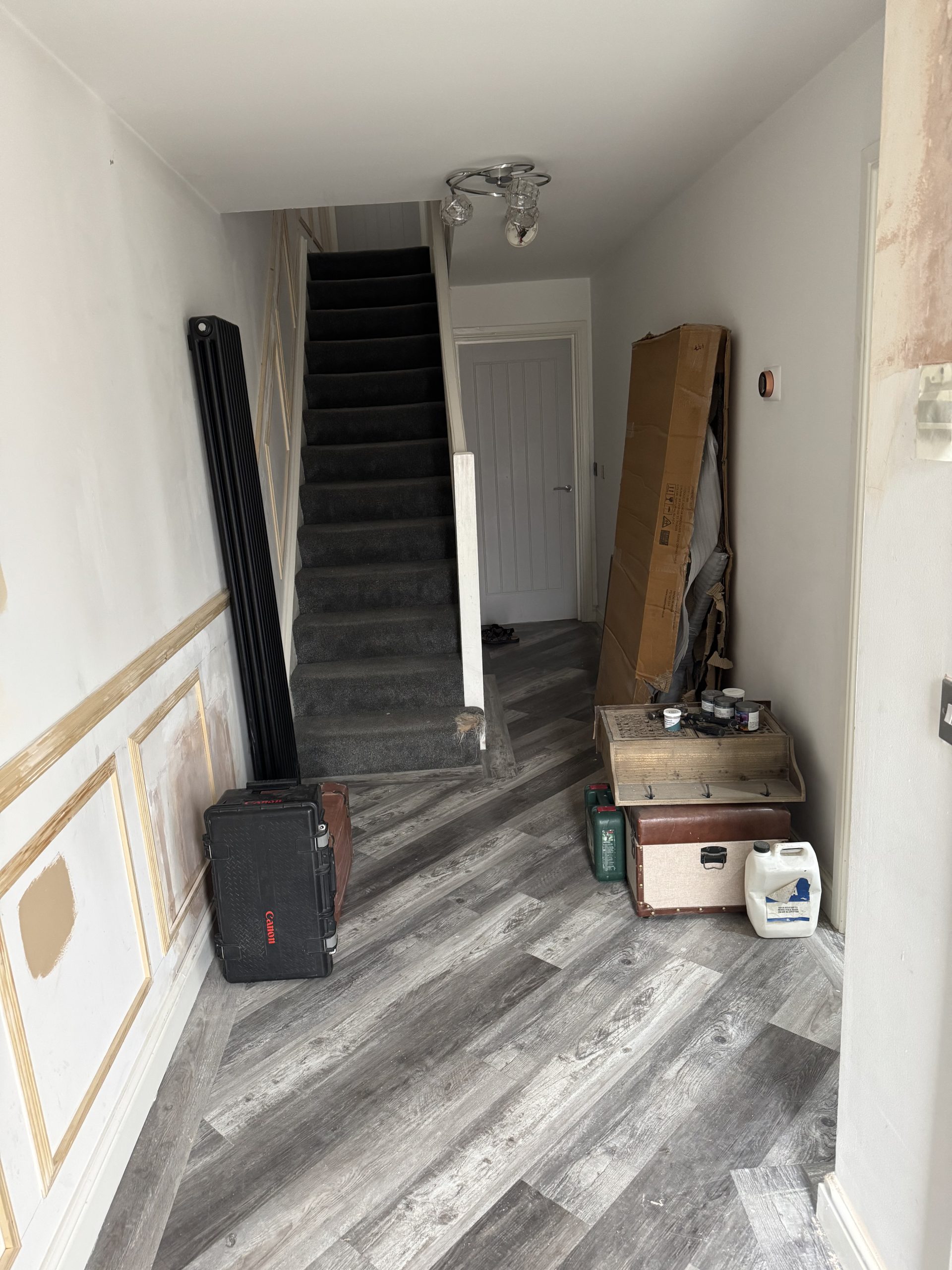 untidy hallway with grey flooring